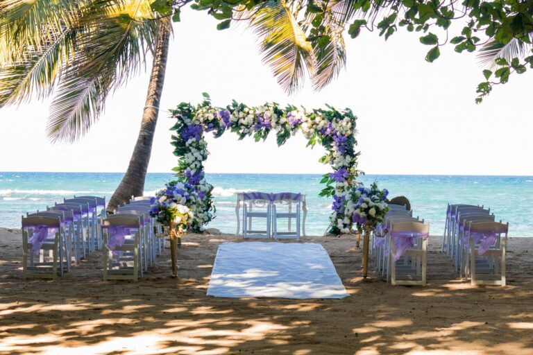 Beautiful outdoor beach wedding setup with floral arch in Puerto Plata.